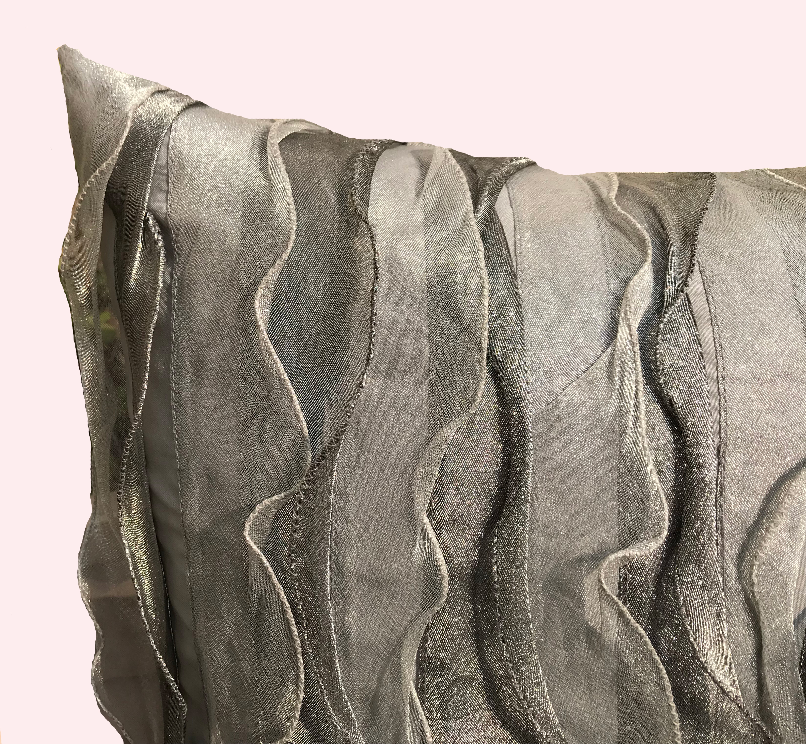 Close view of the silver-grey ruffle texture, showing layered sheer tissue catching the light.